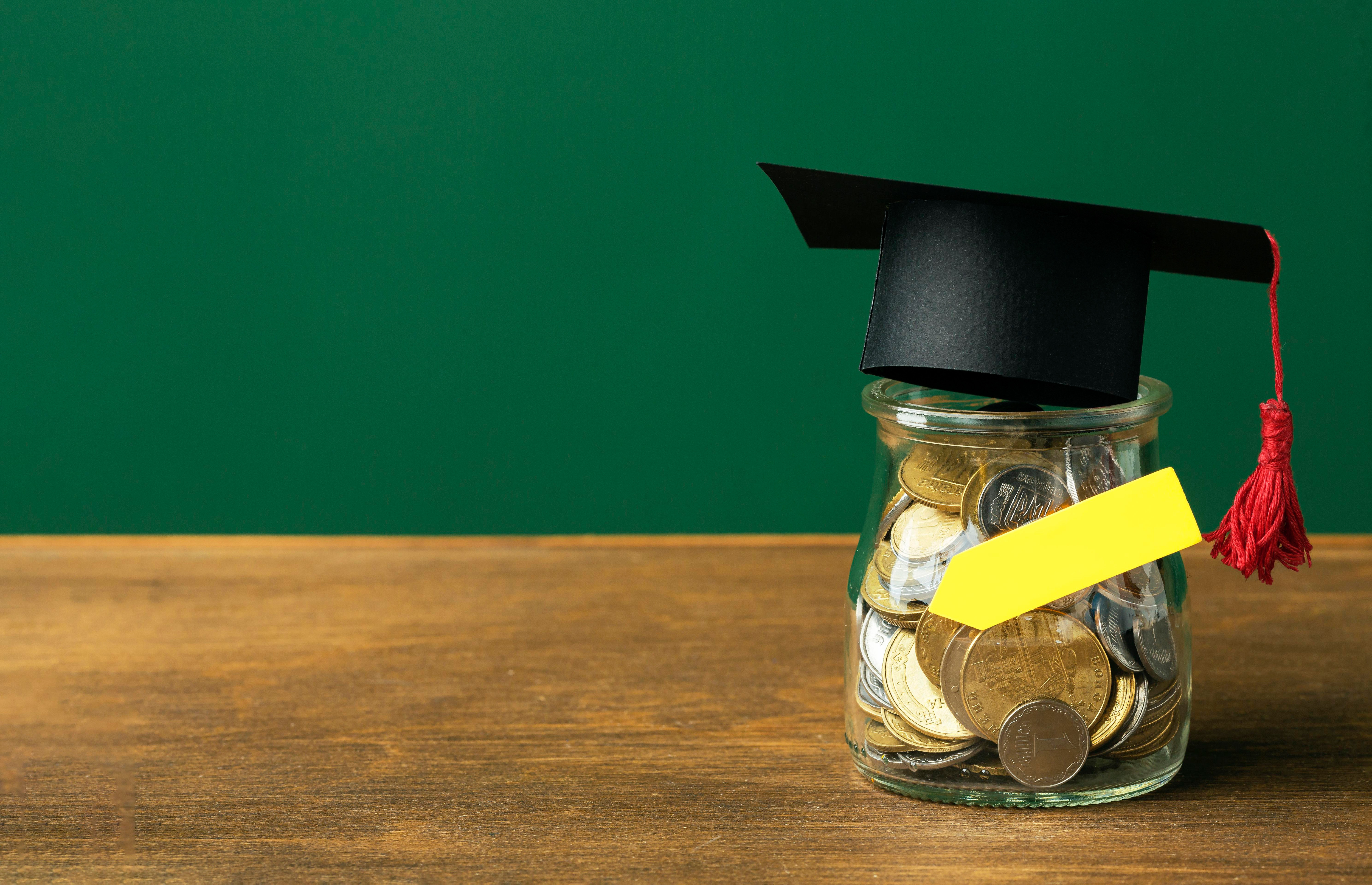 A Jar Of Coins With A Graduation Hat On It - Sourcely Study College Hacks